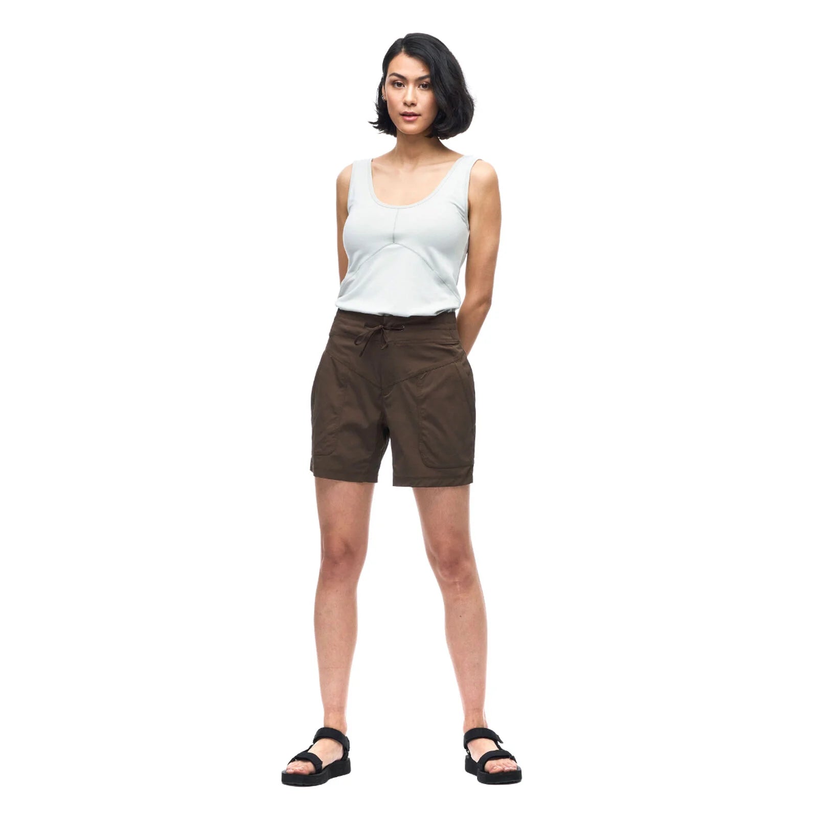 Woman wearing a white tank top and brown shorts on a white background