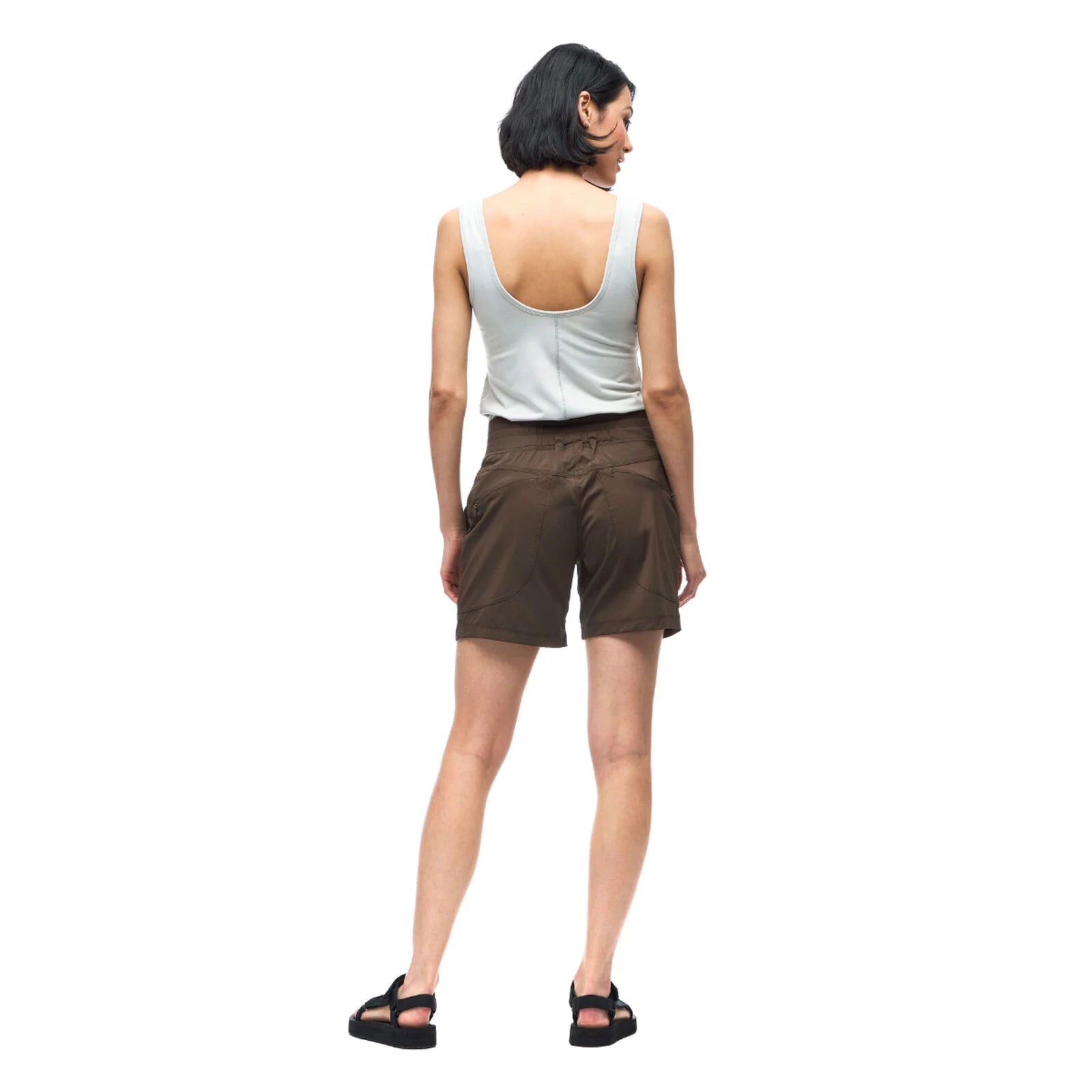 Woman wearing a white tank top and brown shorts on a white background
