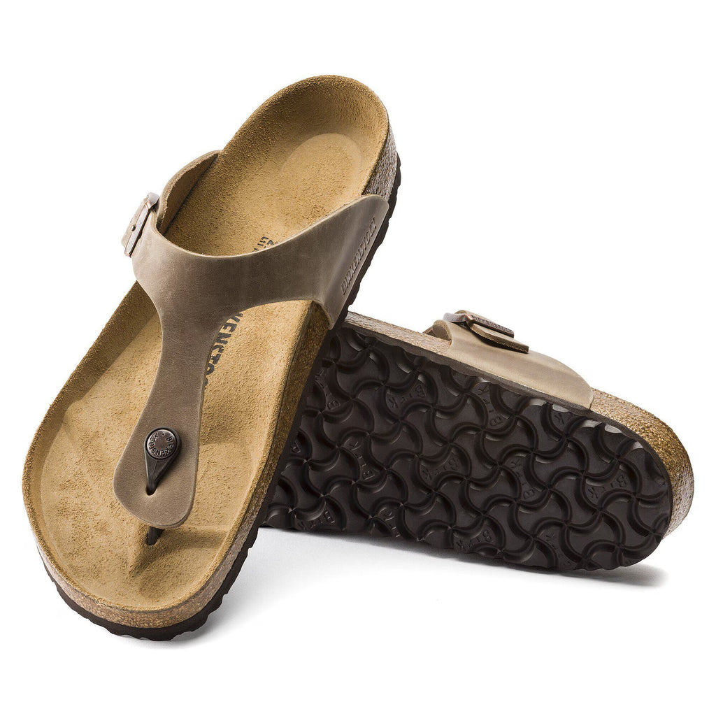 Pair of brown sandals with textured sole on a white background