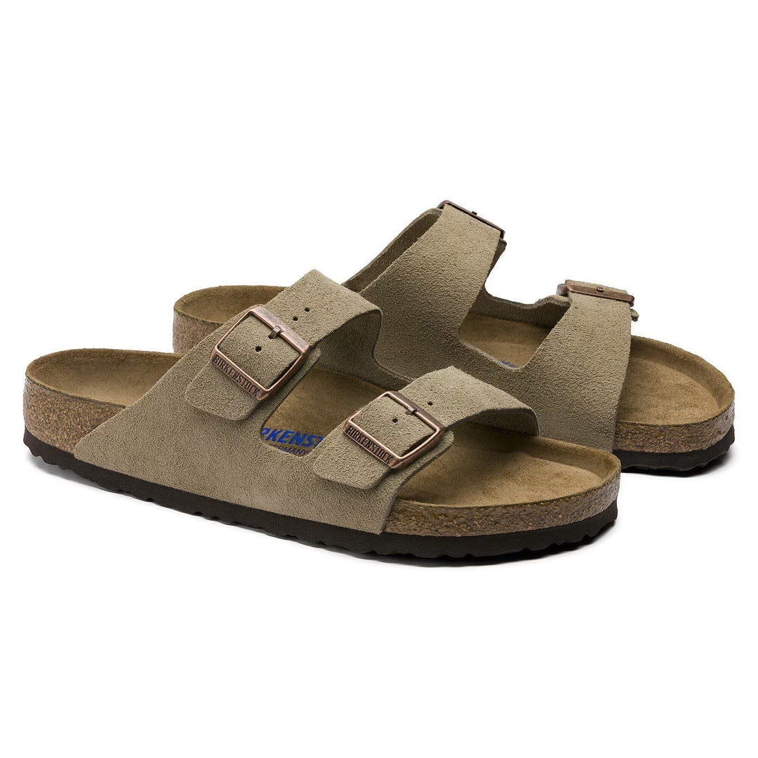 Pair of brown sandals with a visible brand logo on a white background