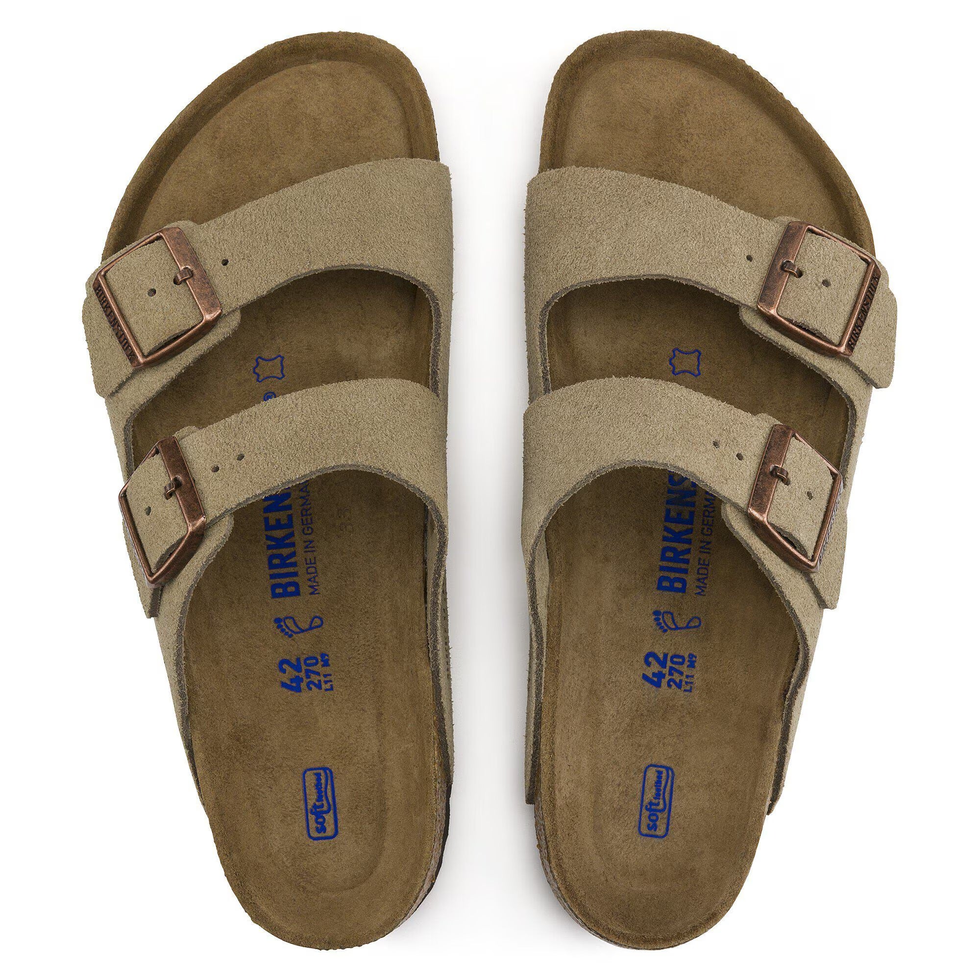 Pair of tan sandals with brown buckles on a white background