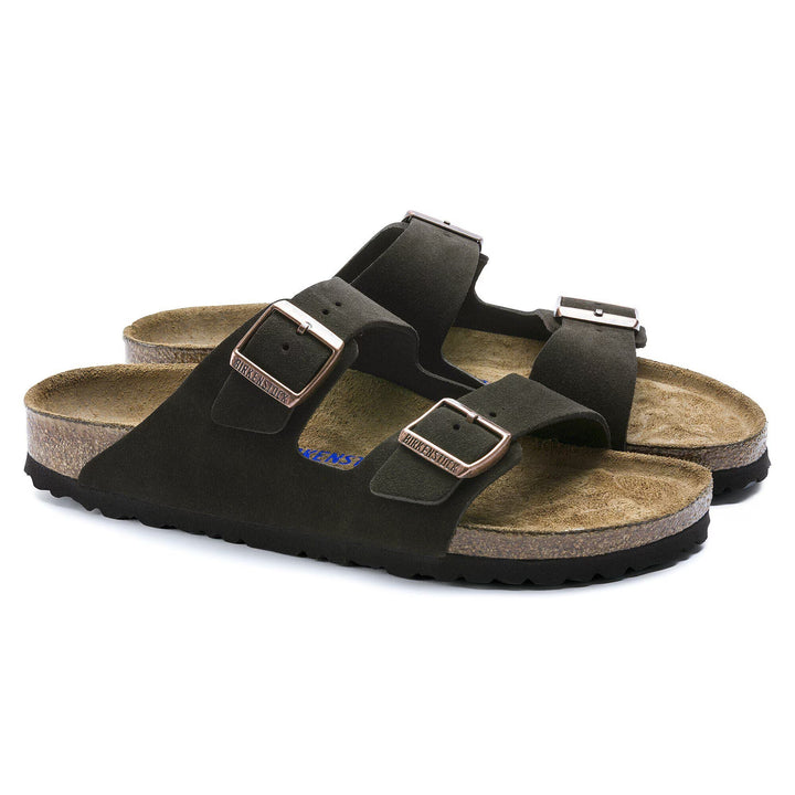 Black sandals with brown soles on a white background