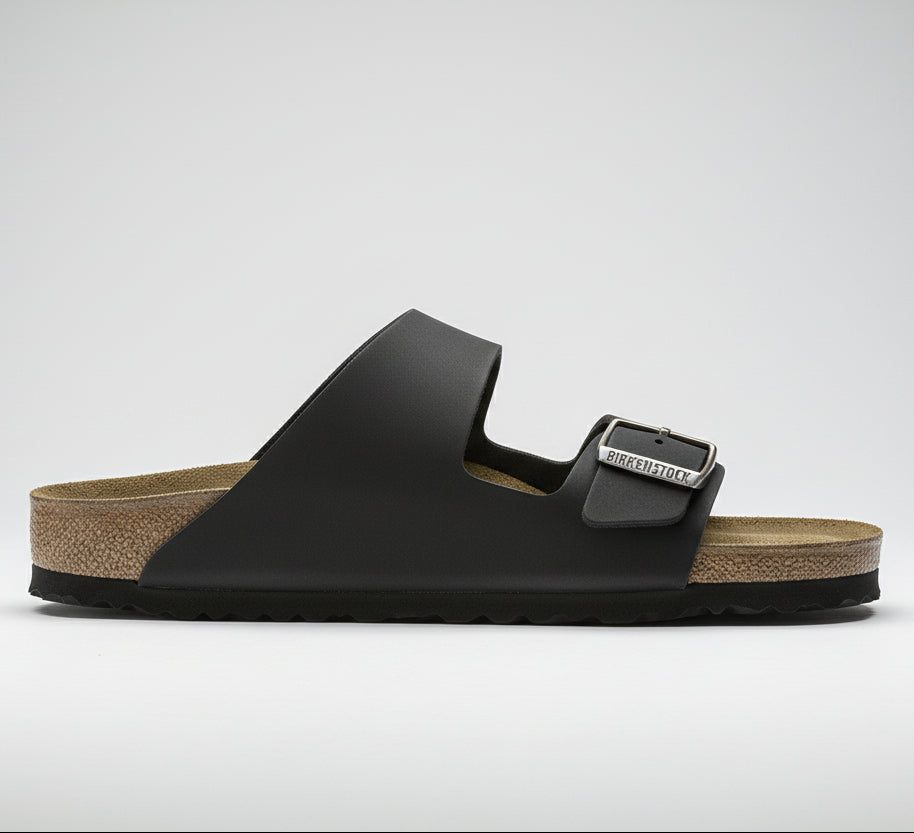 Black sandal with a strap on a white background