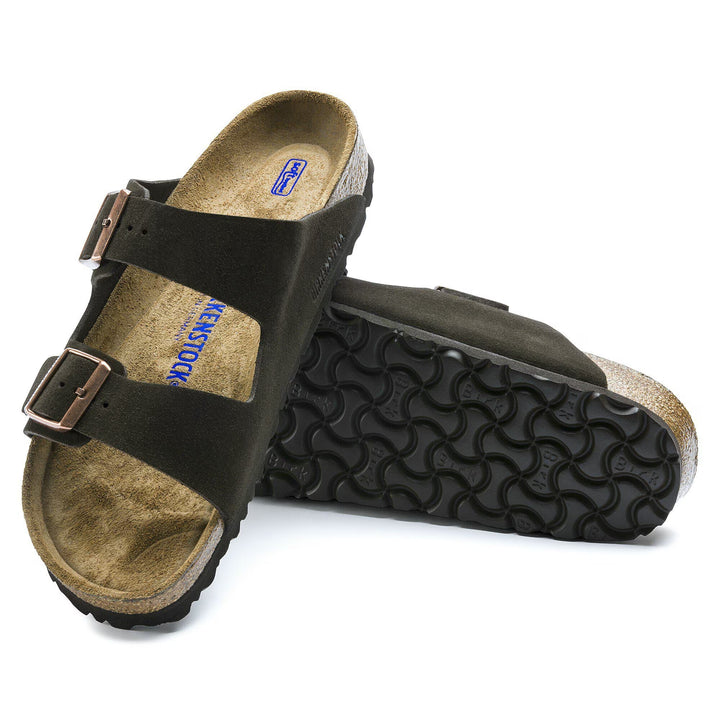 Black sandal with a textured sole on a white background
