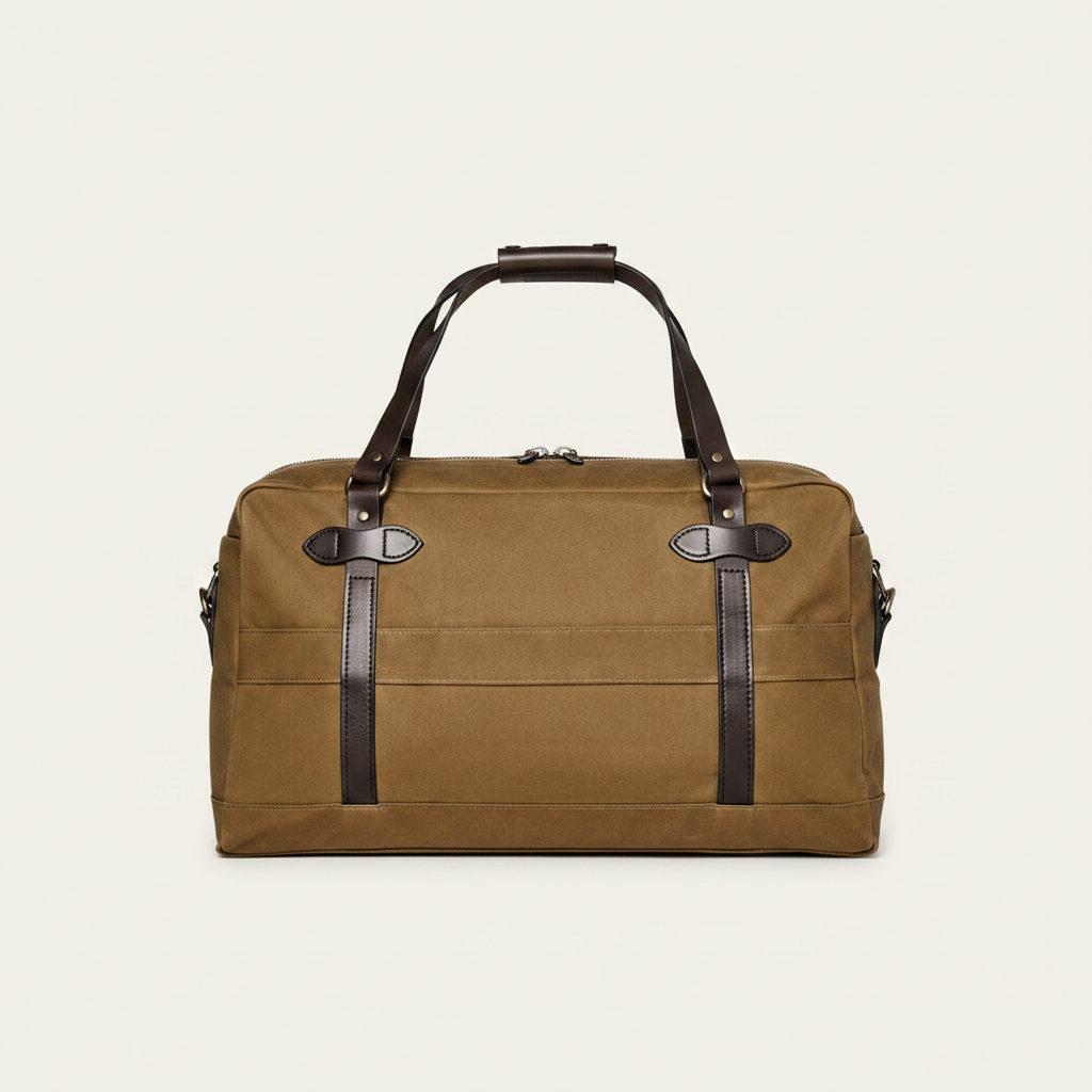 Brown duffel bag with leather straps on a white background