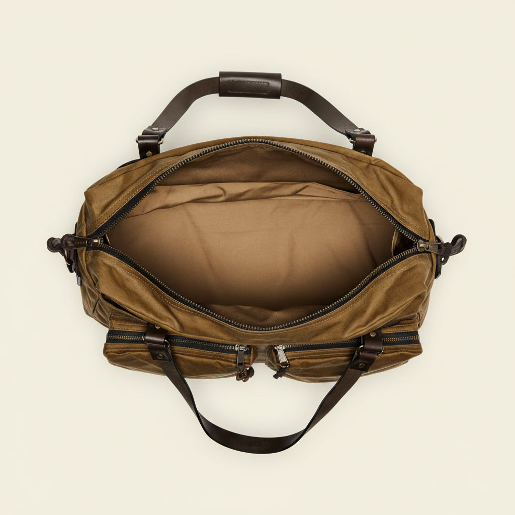 Brown duffel bag with leather straps on a white background