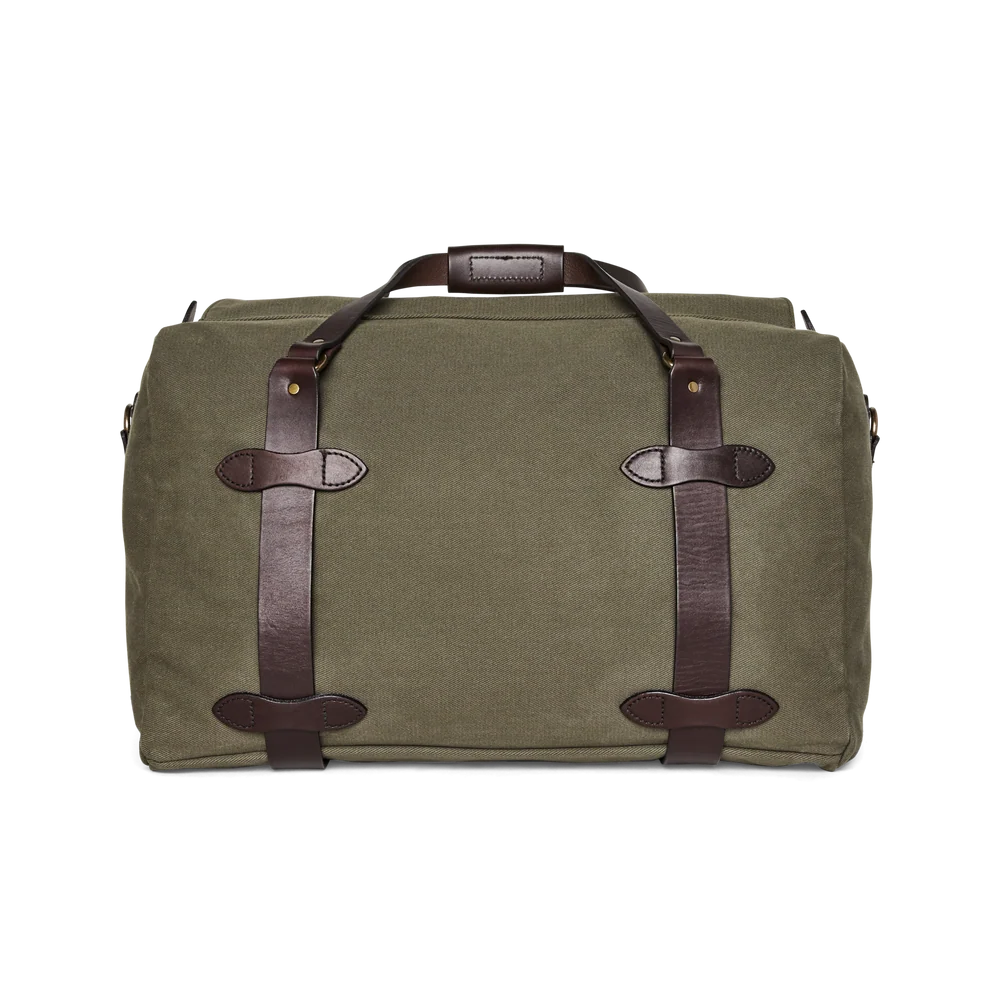 An olive green canvas duffel bag with dark brown leather straps and handles, shown against a plain white background.