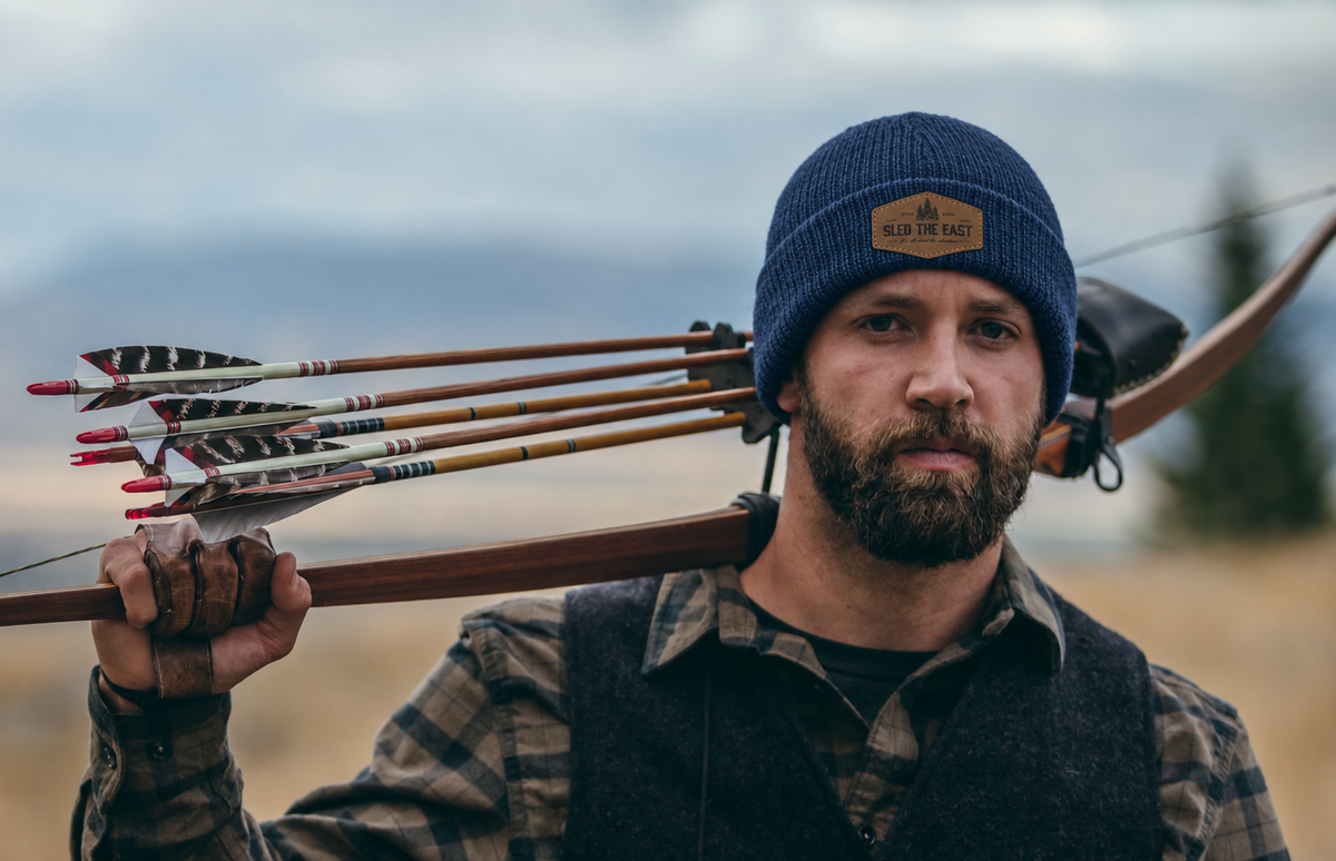 Man wearing a blue sled the east beanie