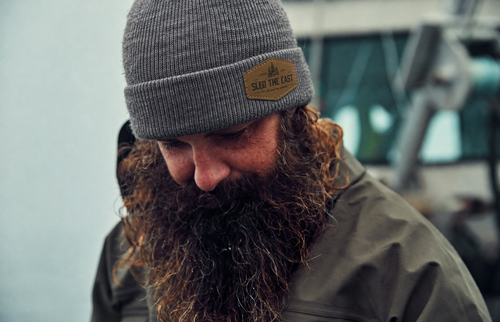 Man wearing a gray sled the east beanie