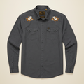 A dark gray long-sleeve button-up shirt by Howler Brothers, featuring embroidered orange blossoms on both shoulders and a small logo patch on the chest pocket, displayed against a solid creme background.