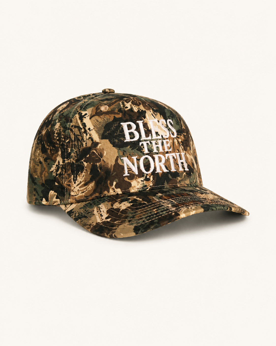 A camouflage baseball cap with 'BLISS THE NORTH' printed in white text on the front, displayed against a clean off-white background.