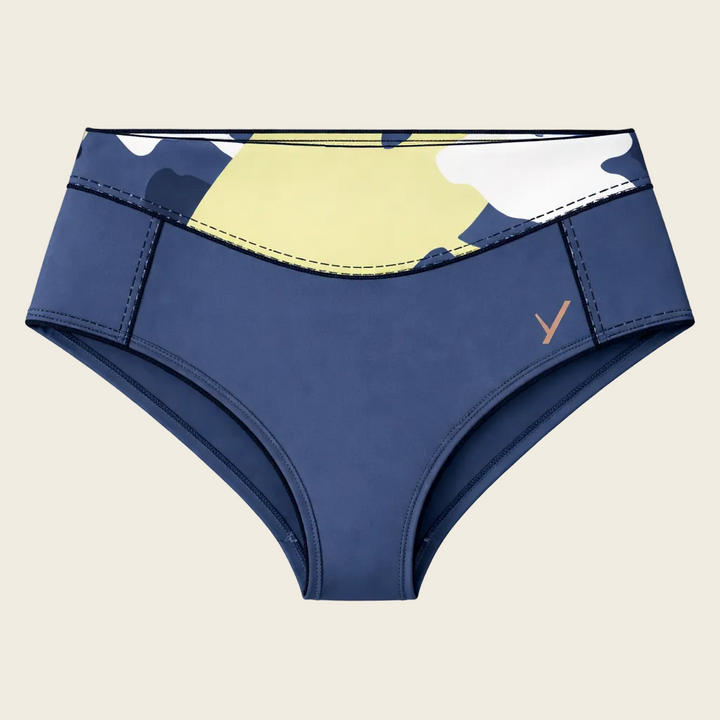 Blue swim bottom with yellow and white camouflage pattern on a beige background