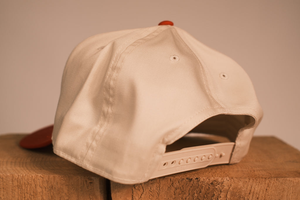 Red brim hat with Pittsburg Pit Crew on it