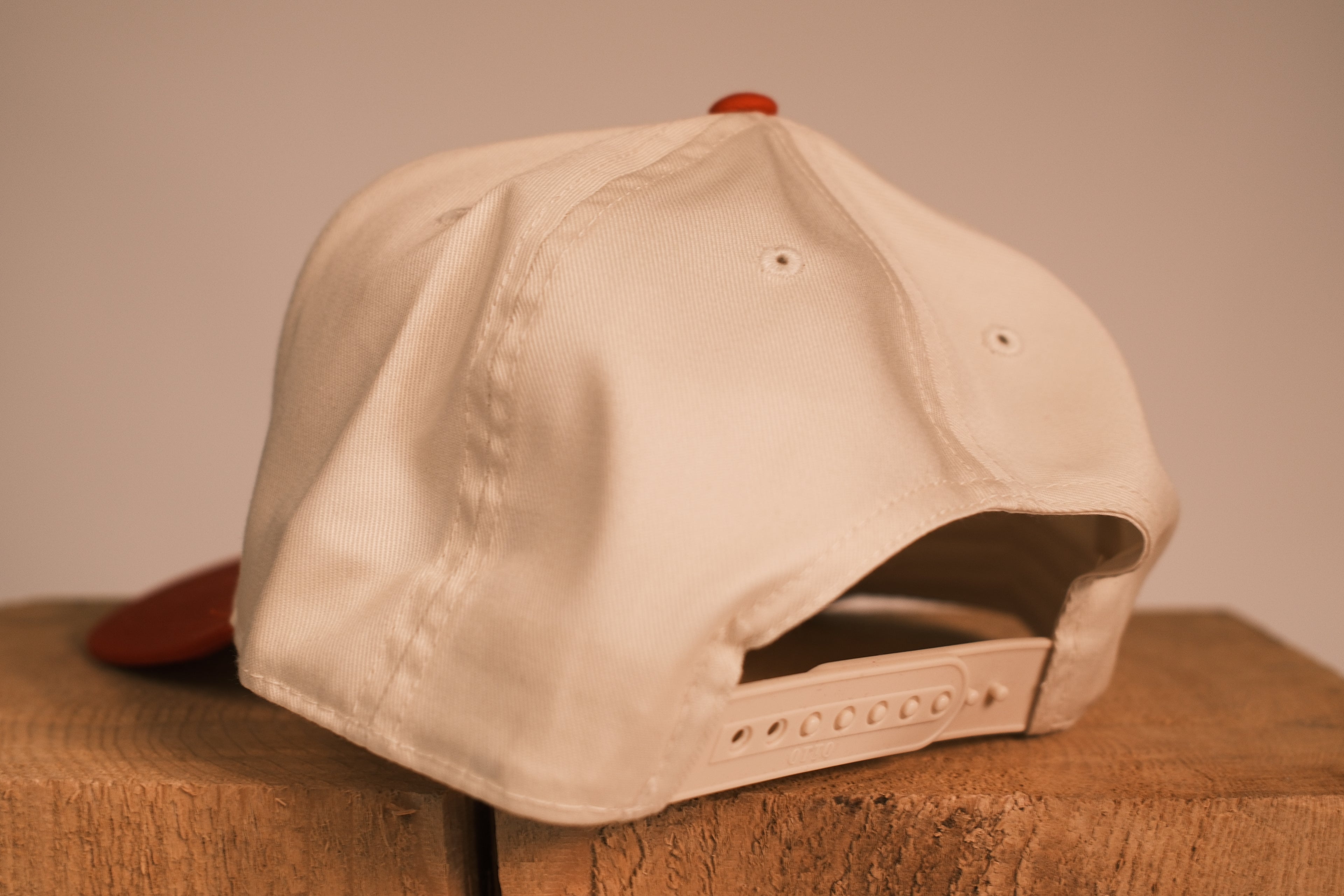 Red brim hat with Pittsburg Pit Crew on it
