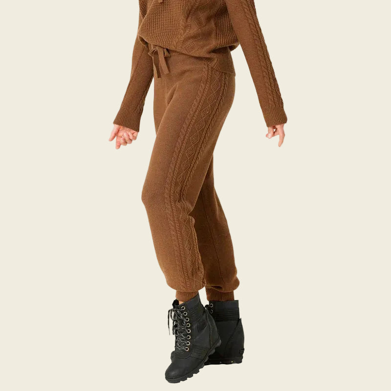 Brown knit outfit with black boots on a white background
