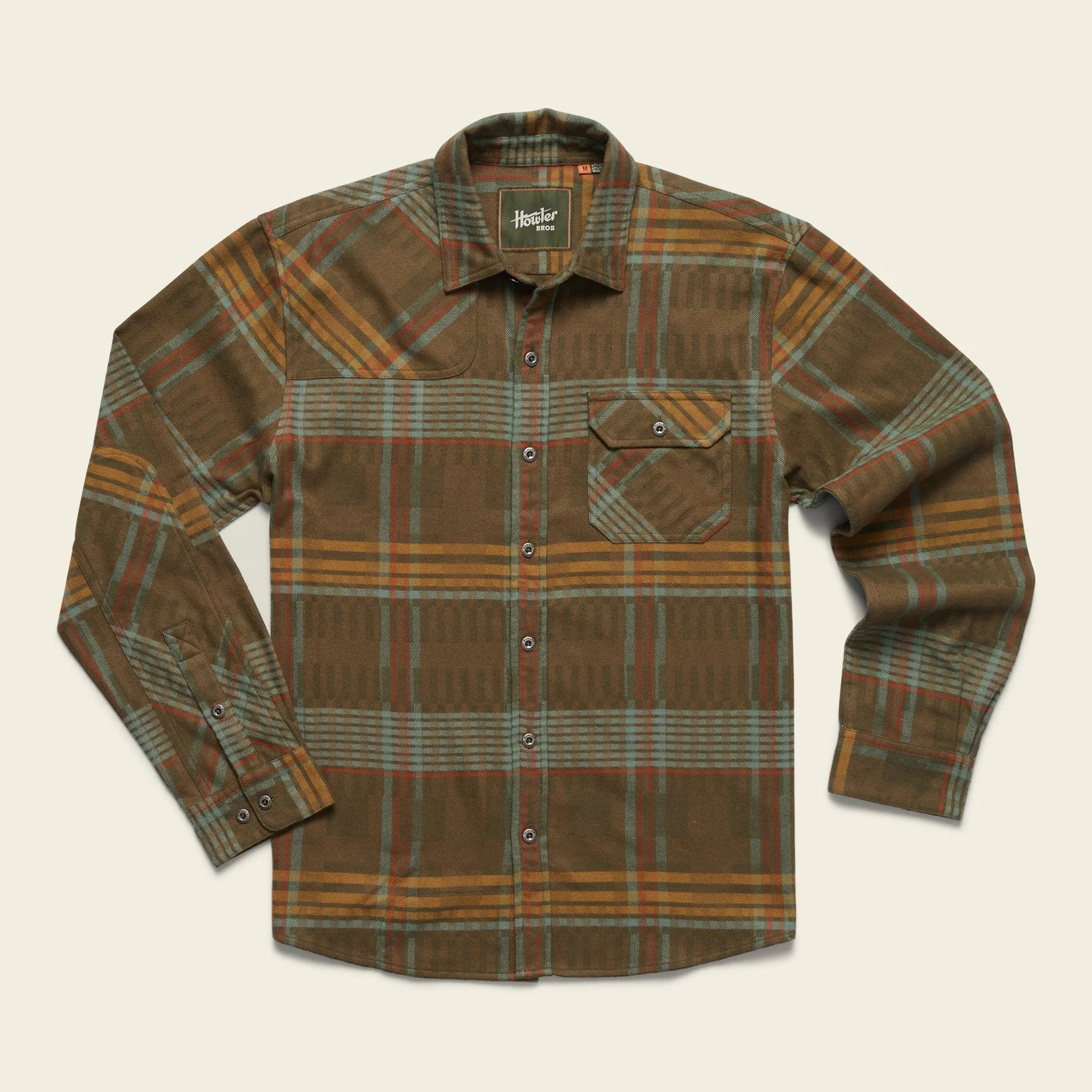 A long-sleeved plaid flannel shirt with a button-through flap pocket on the left chest, reinforced elbow patches, and custom metal buttons.