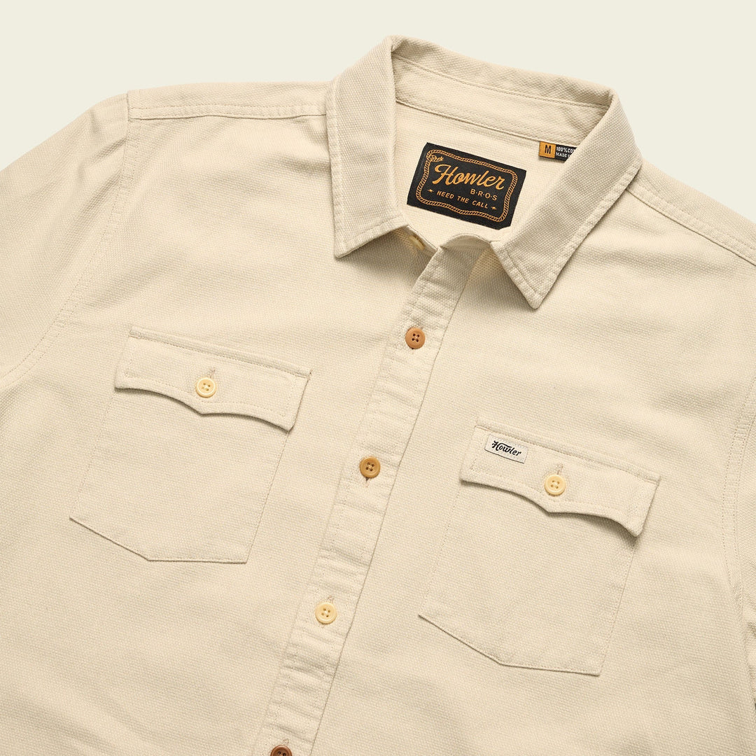 Beige shirt with button details and Howler brand label on a light background