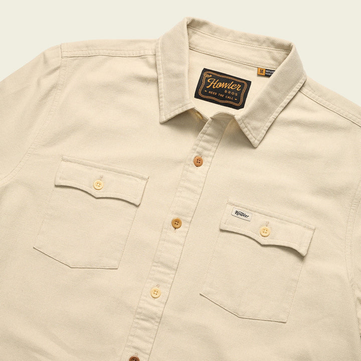 Beige shirt with button details and Howler brand label on a light background