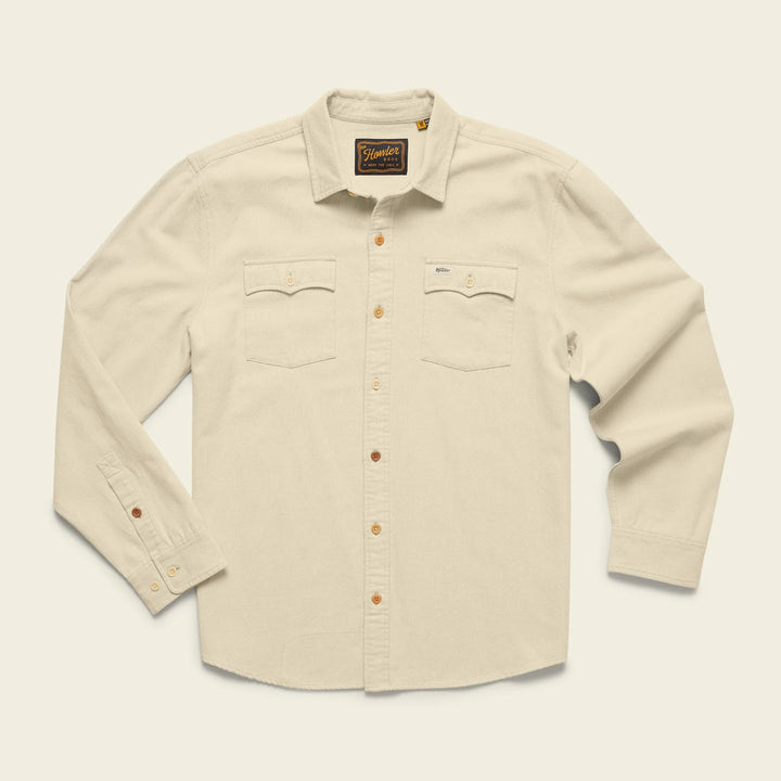 Beige shirt with button details on a light beige background