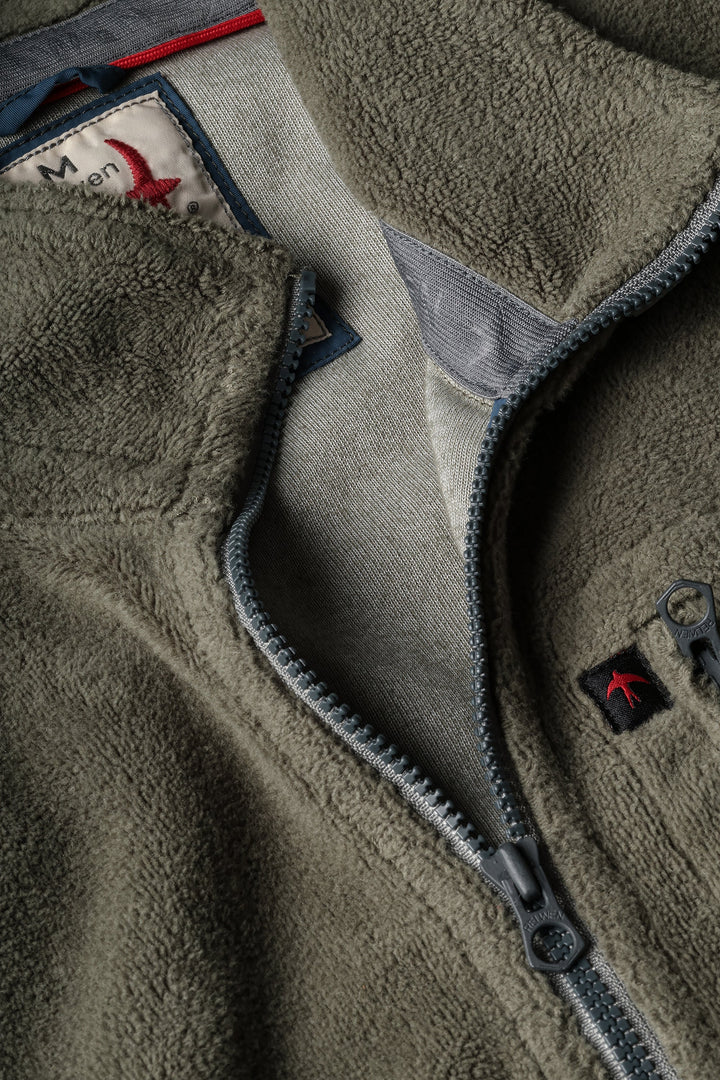 Close-up of a fleece jacket with zipper and brand logo