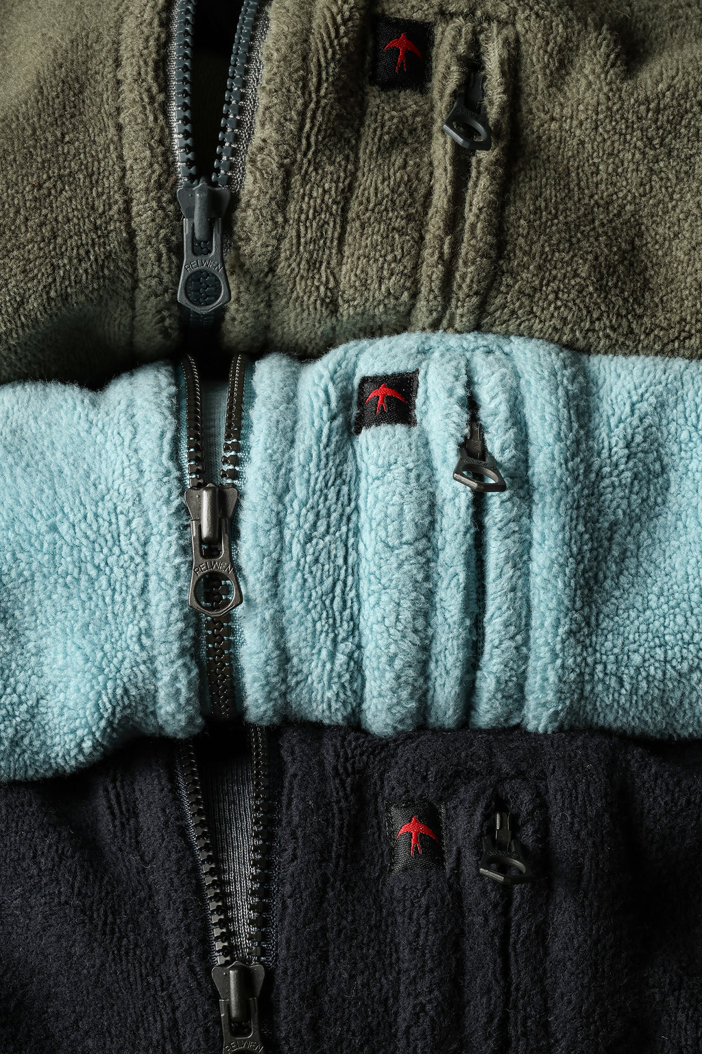 Close-up of a fleece jacket with color blocking and brand logo.