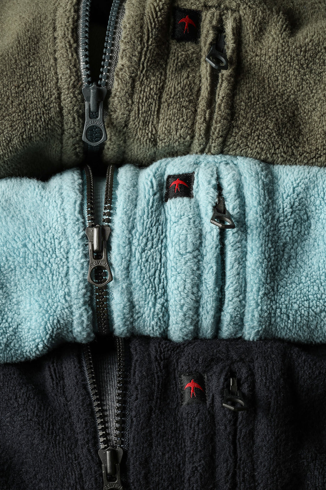 Close-up of a fleece jacket with color blocking and brand logo.