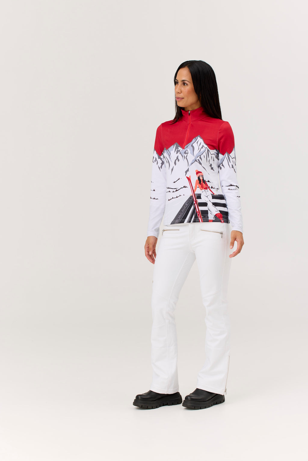 Person wearing a red and white patterned top with white pants on a white background