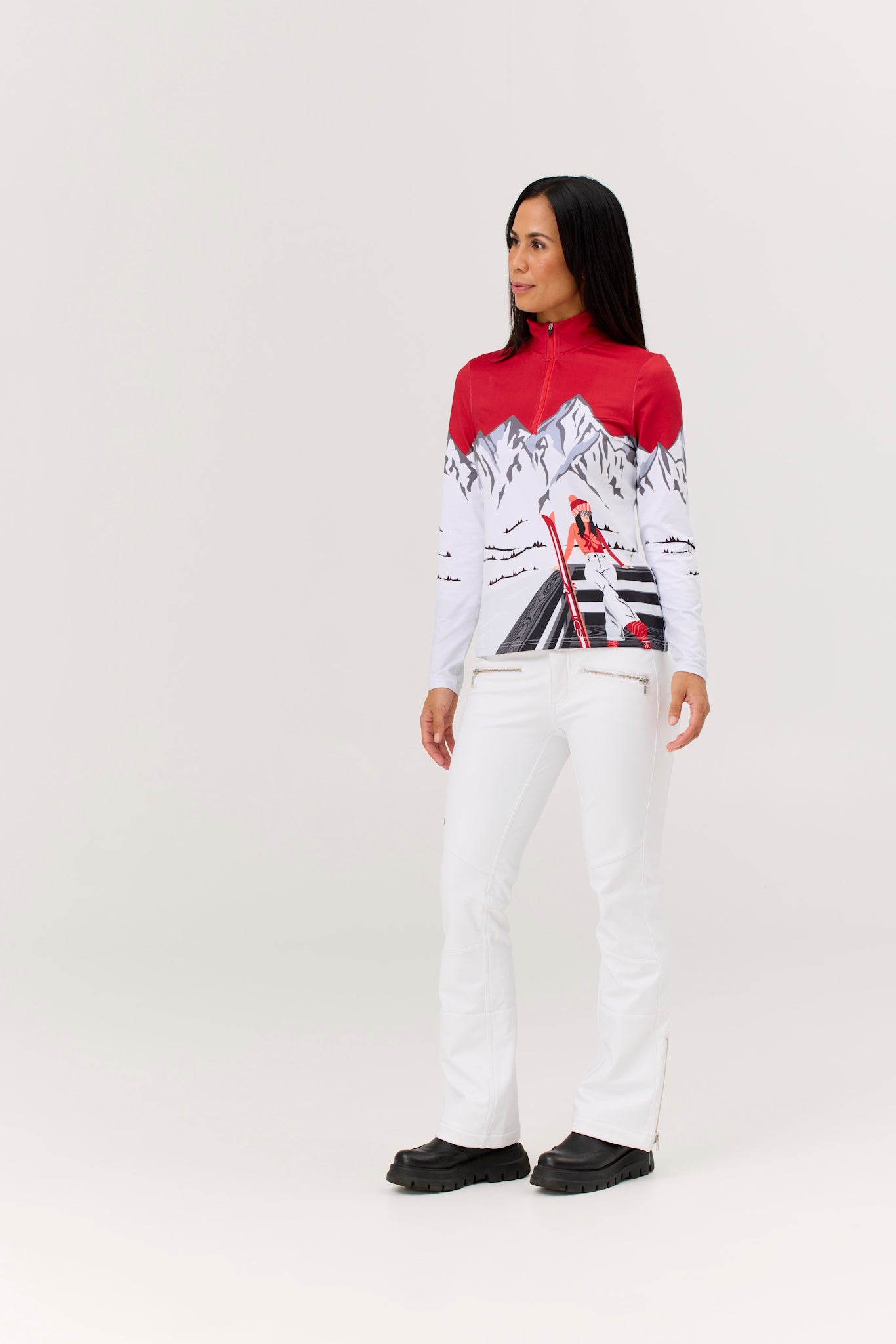 Person wearing a red and white patterned top with white pants on a white background