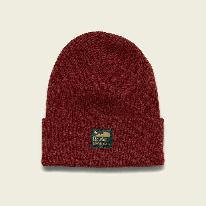 Red beanie with a logo on a beige background