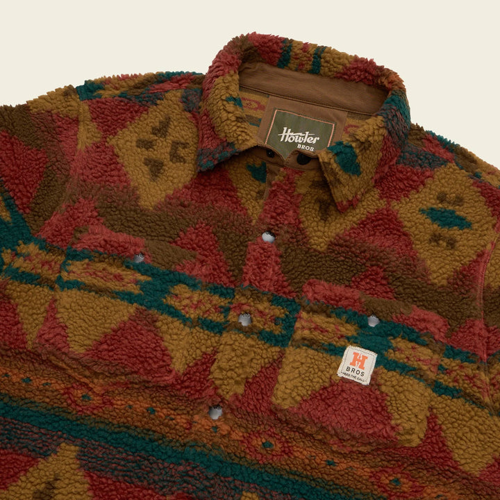 Patterned shirt with a brand label on a neutral background