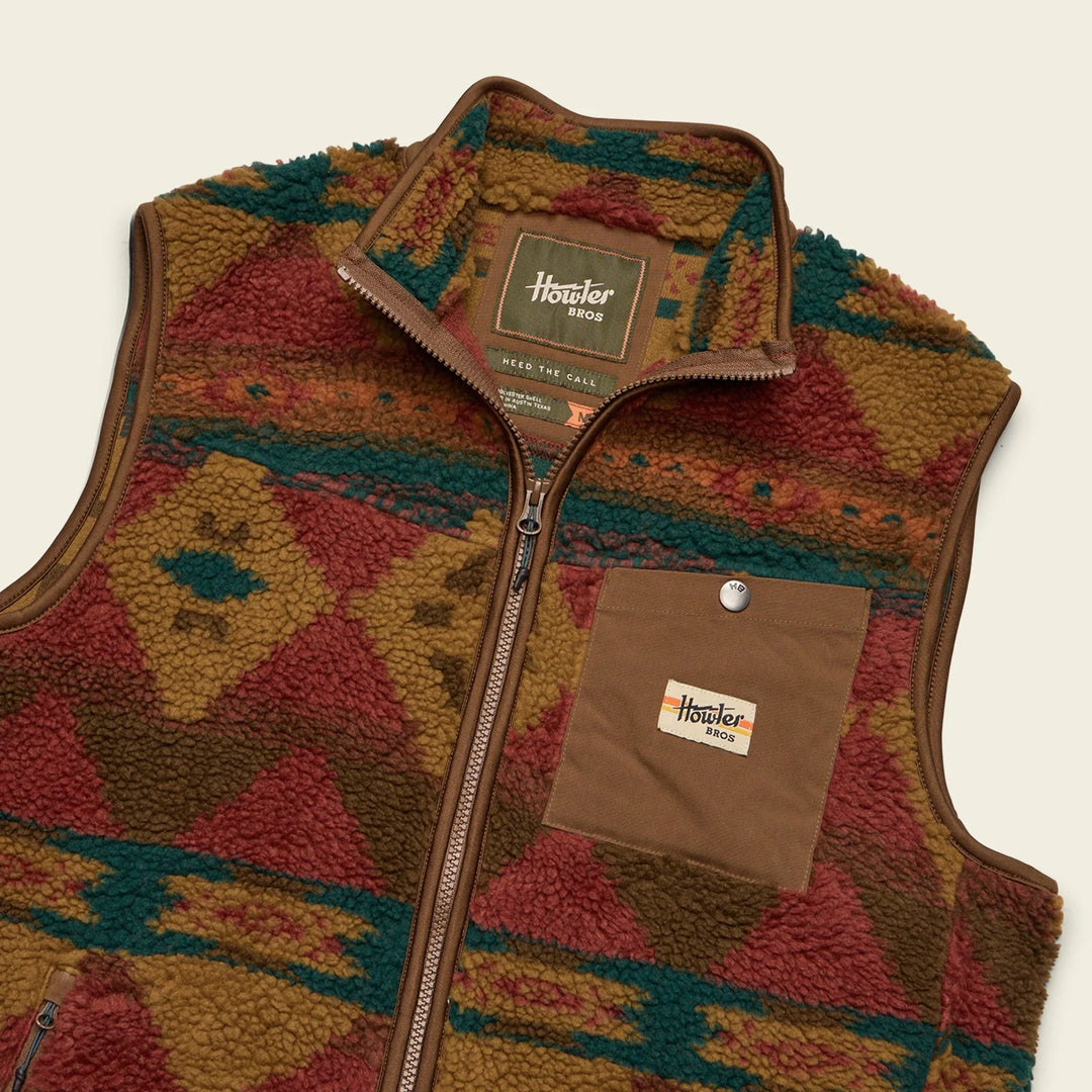 Patterned vest with visible brand logo on a beige background