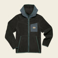 Black fleece jacket with green accents on a beige background