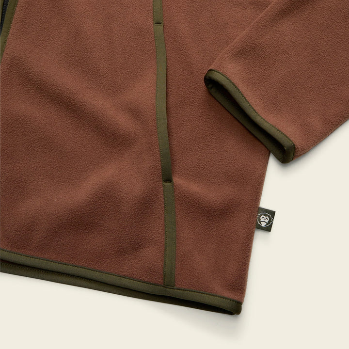 Brown fleece fabric with a brand tag on a white background
