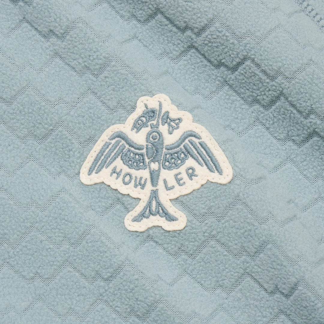 Embroidered logo on a textured blue fabric background