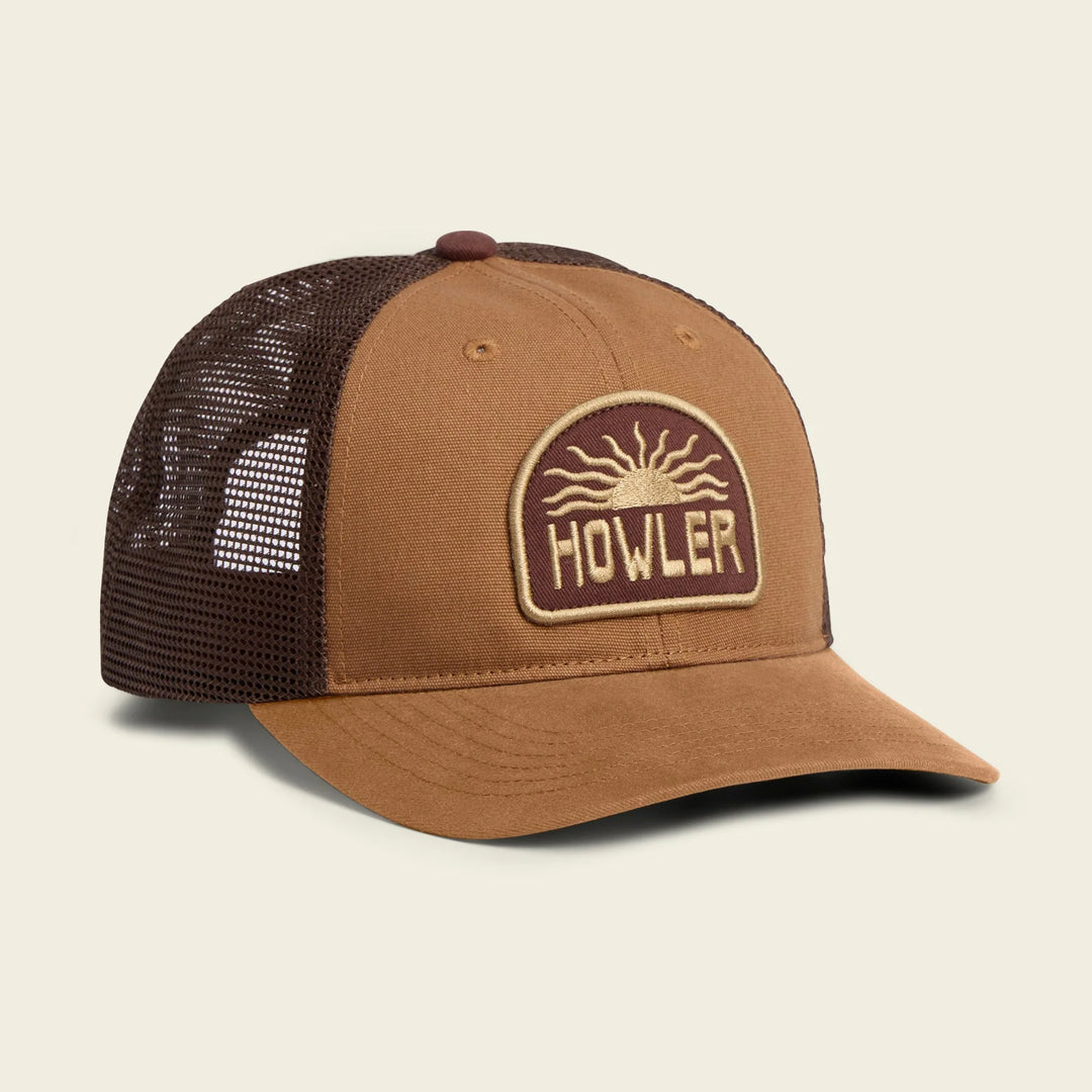 Brown trucker cap with mesh back and 'Howler' logo on a beige background