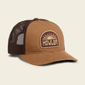 Brown trucker cap with mesh back and 'Howler' logo on a beige background