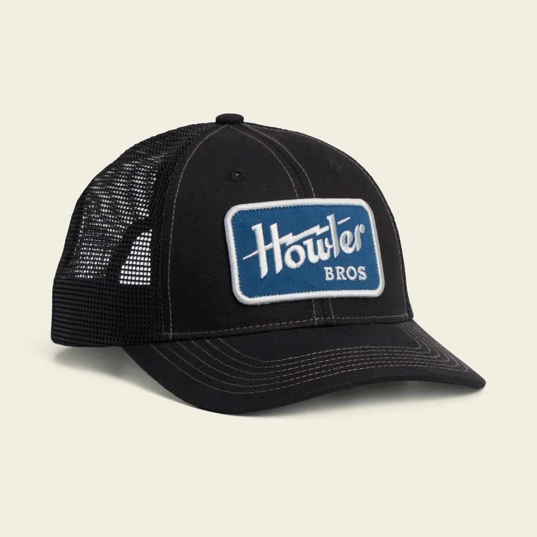 Black mesh cap with 'Howler Bros' logo on a beige background