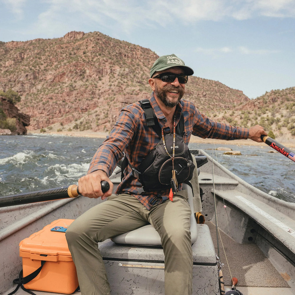 Man on a boat in a mountainous area