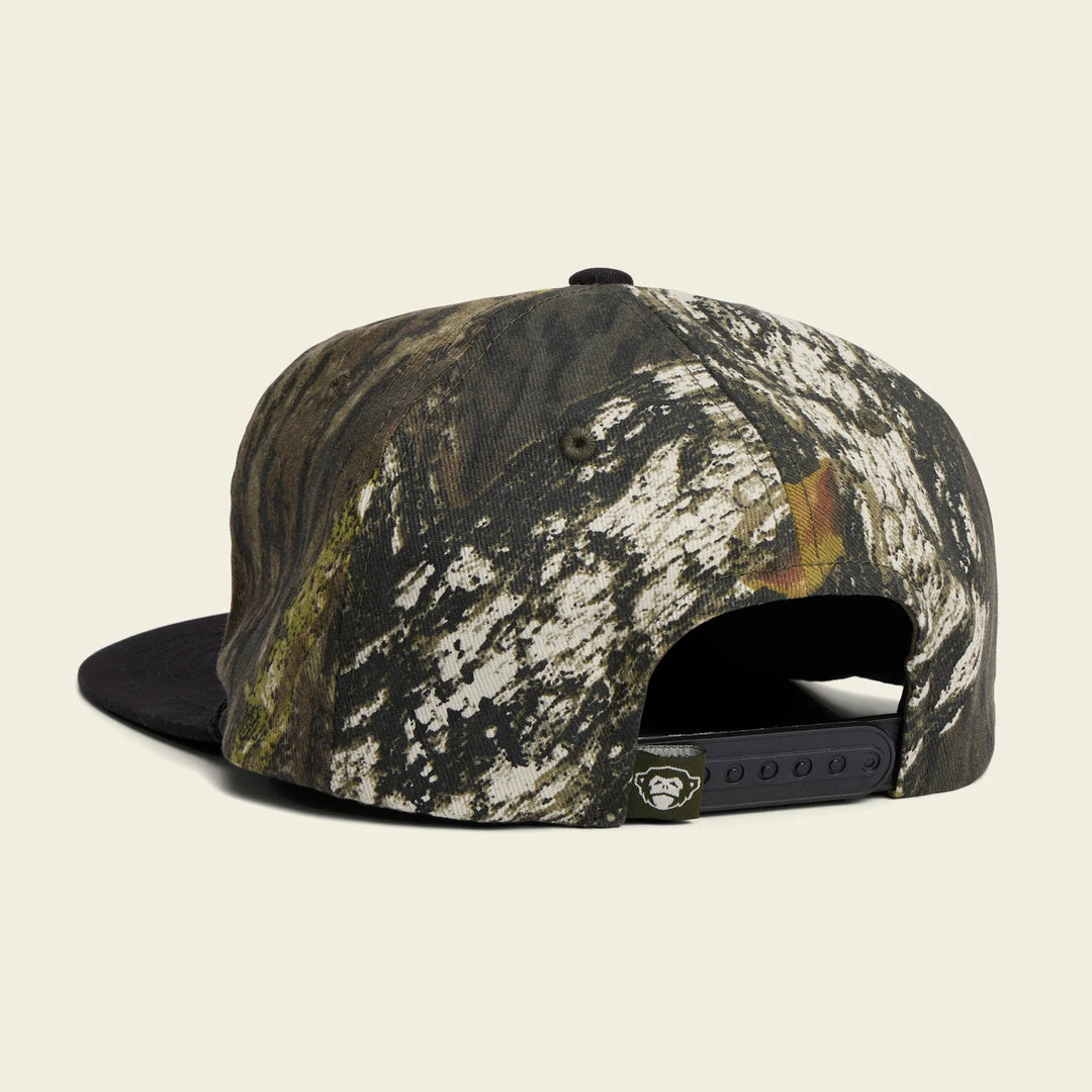 Camouflage-patterned cap on a beige background