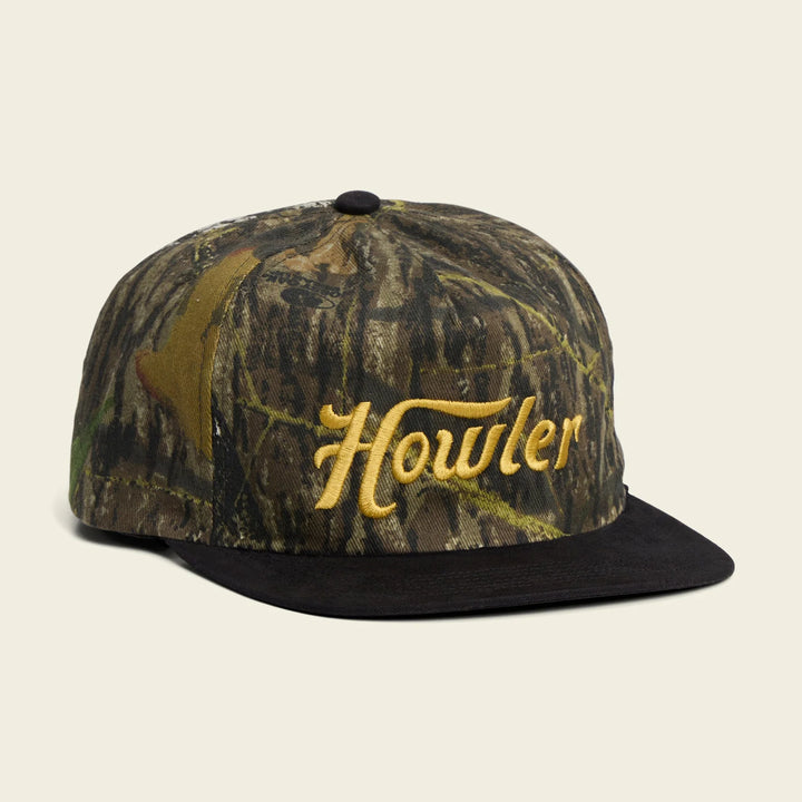 Camouflage cap with 'Howler' logo on a beige background
