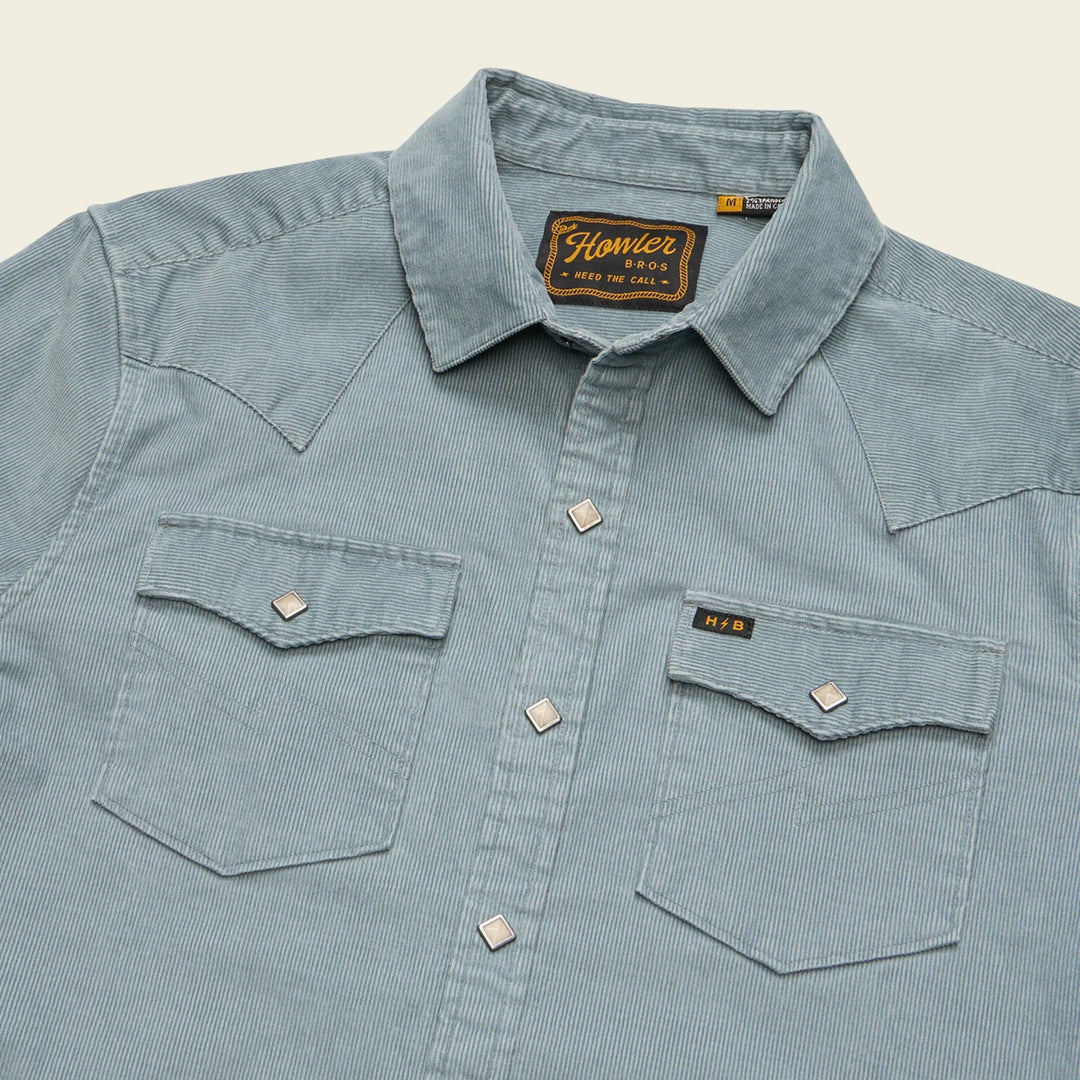 Light blue corduroy shirt with 'Flanner' label on a beige background