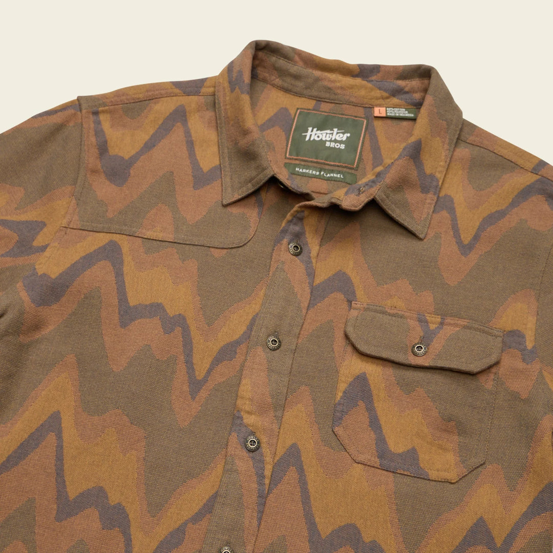Camouflage shirt with a brand label on a beige background