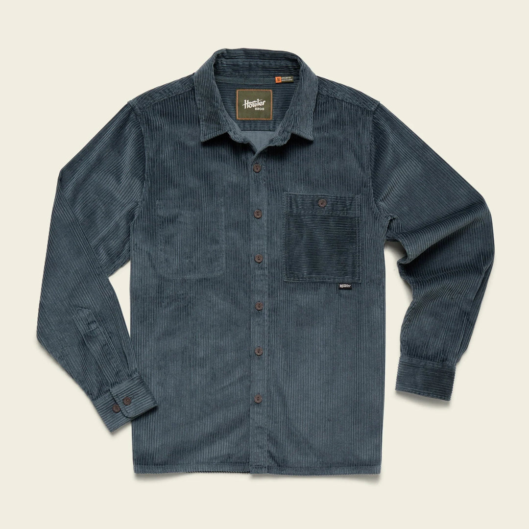 Blue corduroy shirt with button details on a beige background