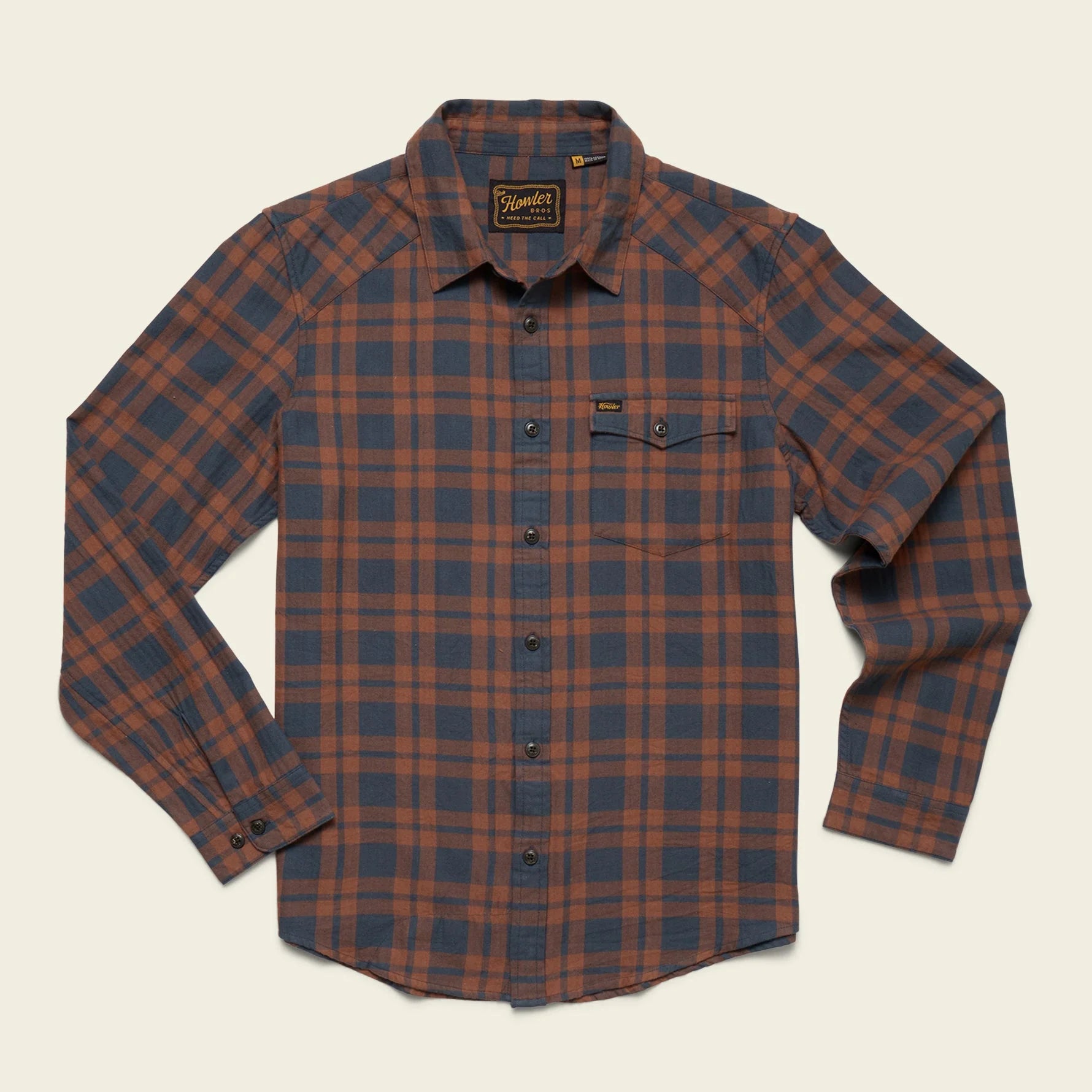 Howler Brothers plaid shirt with brown and blue pattern on a beige background