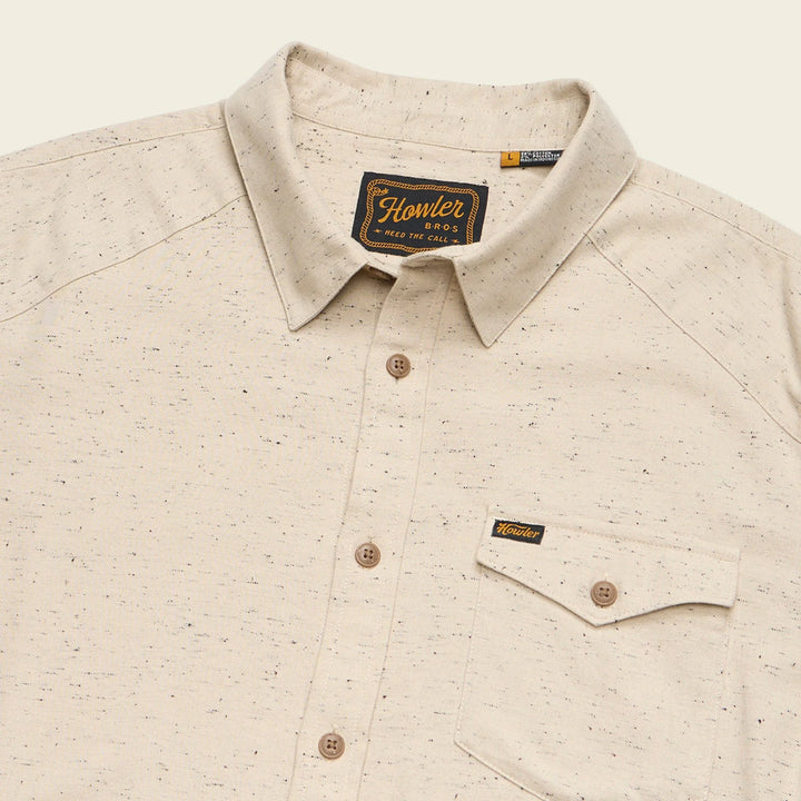 Beige patterned shirt with Howler brand label on a beige background