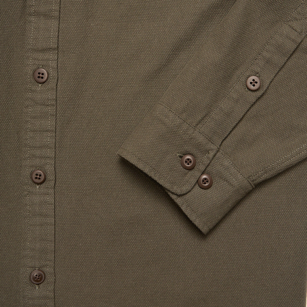 Close-up of a green shirt with button details