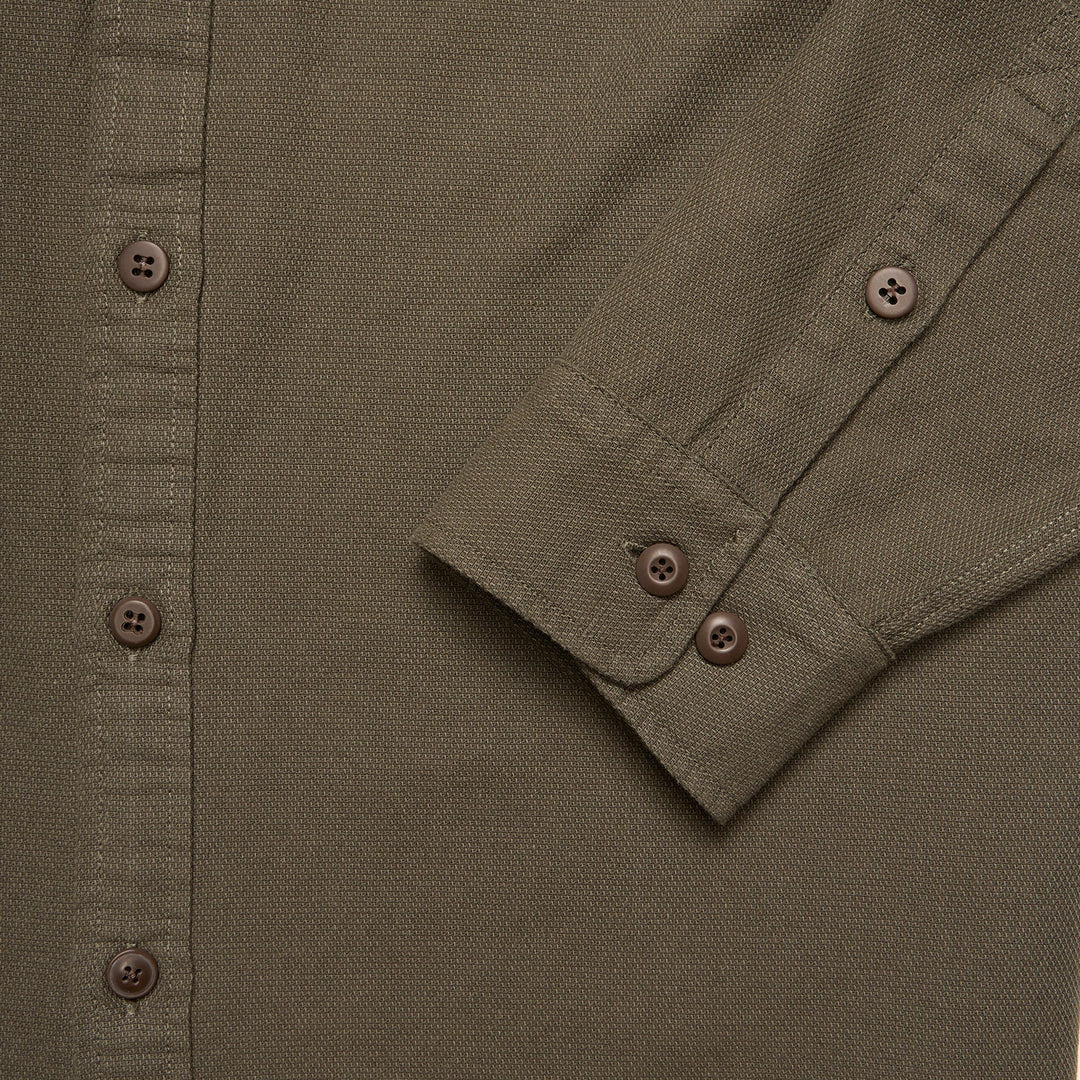 Close-up of a green shirt with button details