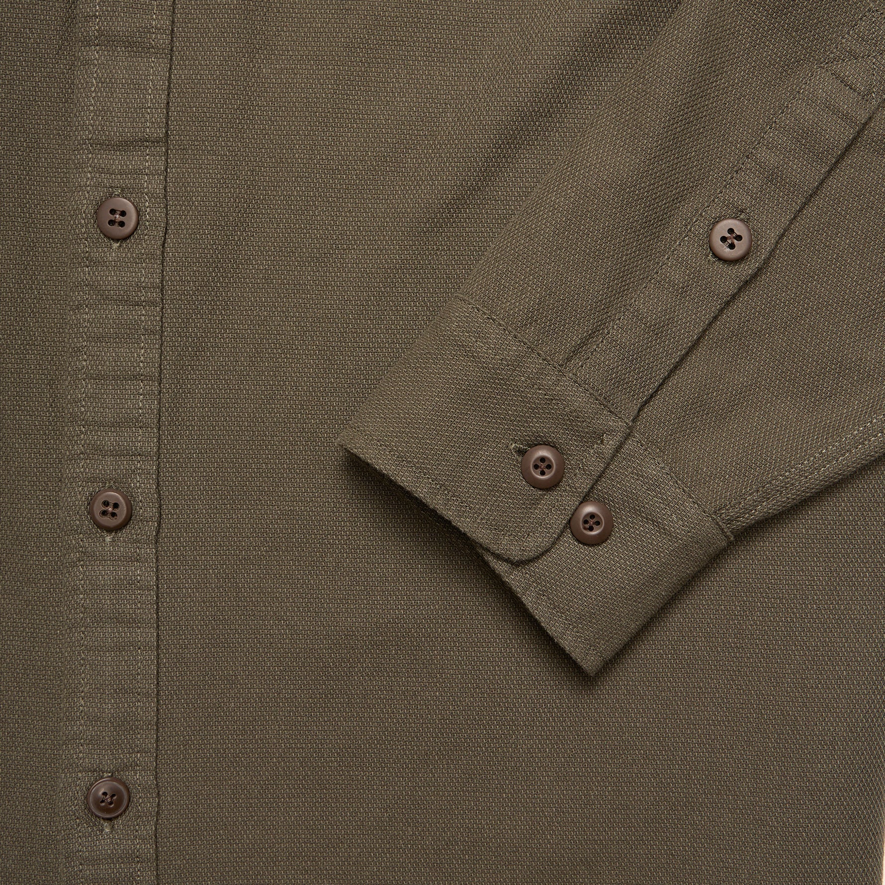 Close-up of a green shirt with button details