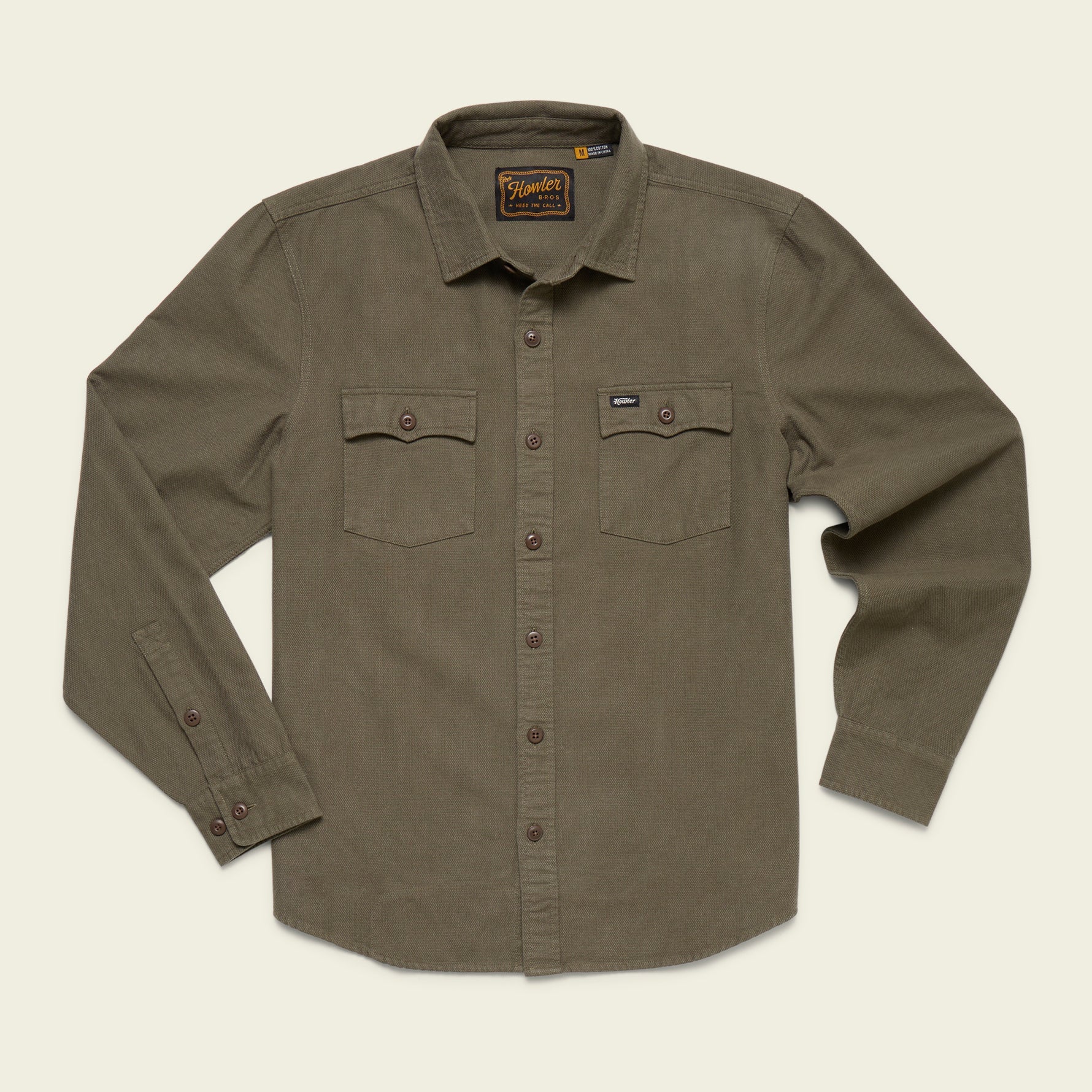 Olive green shirt with button details on a beige background
