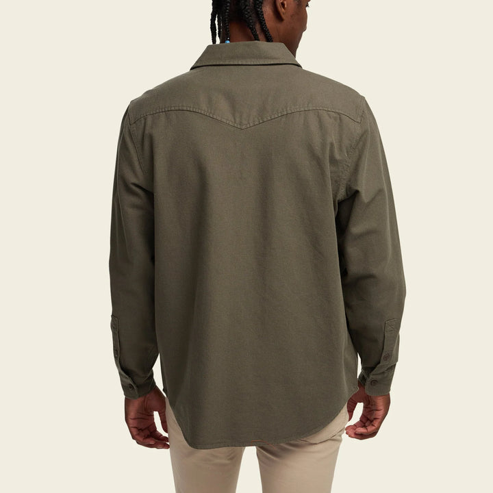Person wearing a green shirt on a beige background